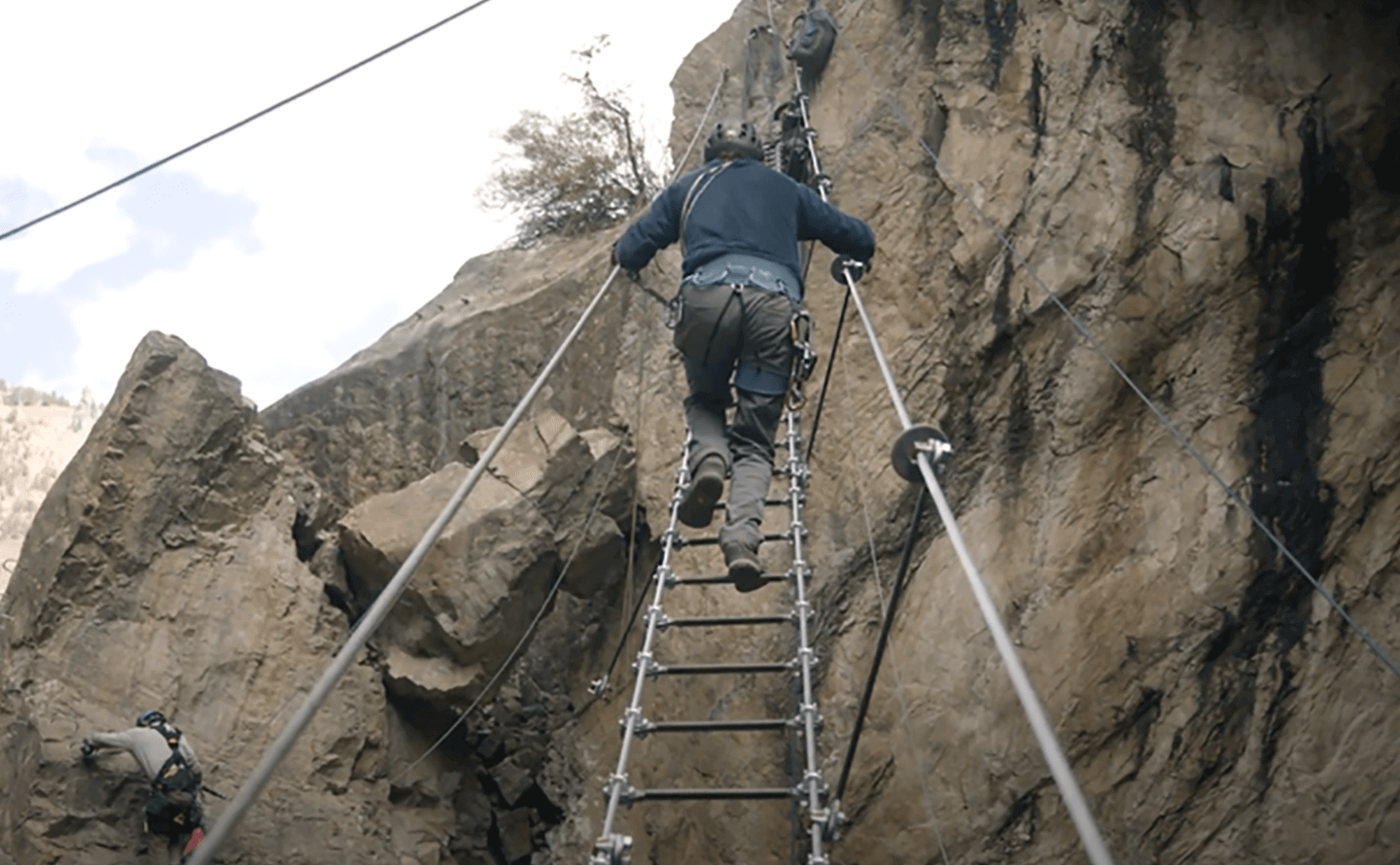 person climbing wire suspended stairs